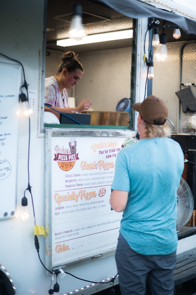 A guest ordering from the Buster's Pizza Pies food truck at Sparks of Giving